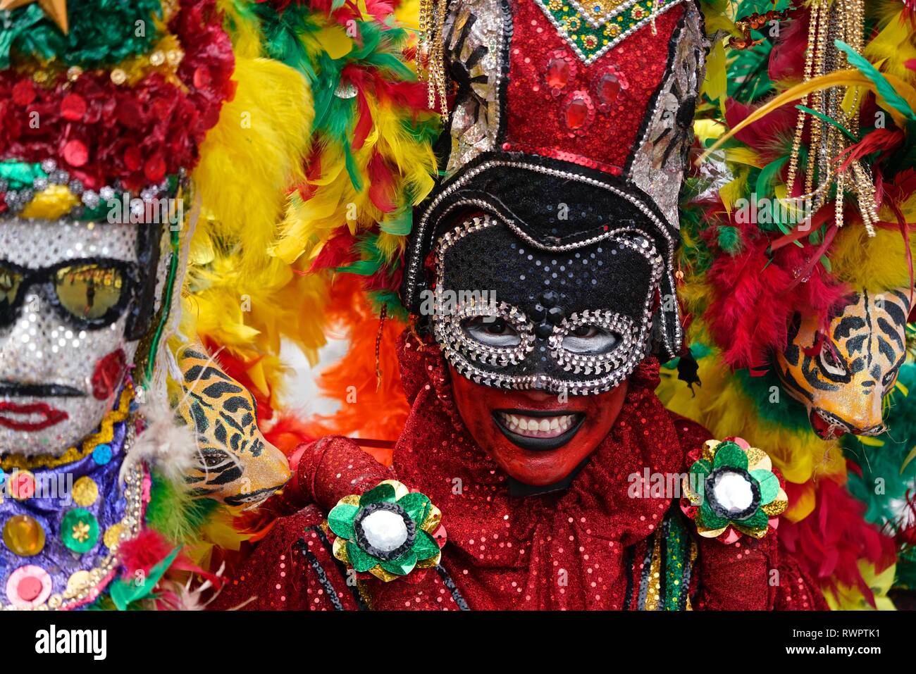 Dancers wearing colorful costumes at the Battle of Flowers Stock Photo