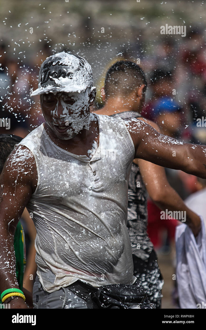 Valle de Chota, Ecuador- March 4, 2019: man drenched in foam during the 'Olas del Rio' carnaval Stock Photo