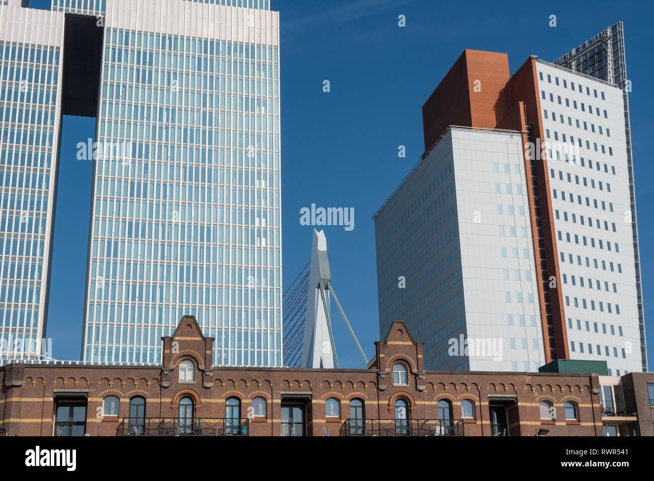 Rotterdam, Netherlands - March 26, 2016: Classical and modern architecture, on the left left De Rotterdam building by Rem Koolhaas, on the right KPN tower by Renzo Piano, Kop van Zuid and erasmus bridge in the middle Stock Photo