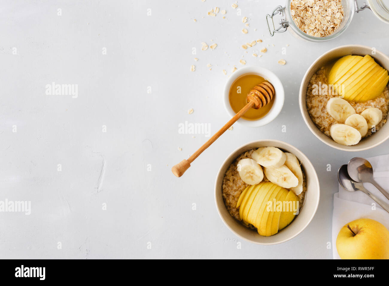 Healthy breakfast top view. Oatmeal with with fruits (apples, bananas