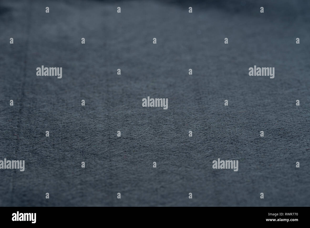 dark gray color felt backgroun texture selective focus Stock Photo