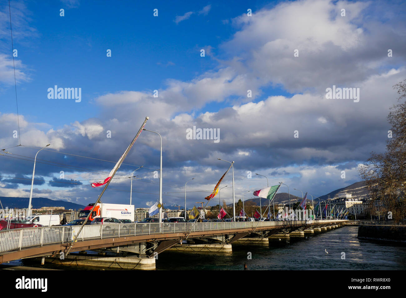 Flags of Swiss cantons fly in the wind, Mont-Blanc Bridge, Geneva, Swiss Stock Photo