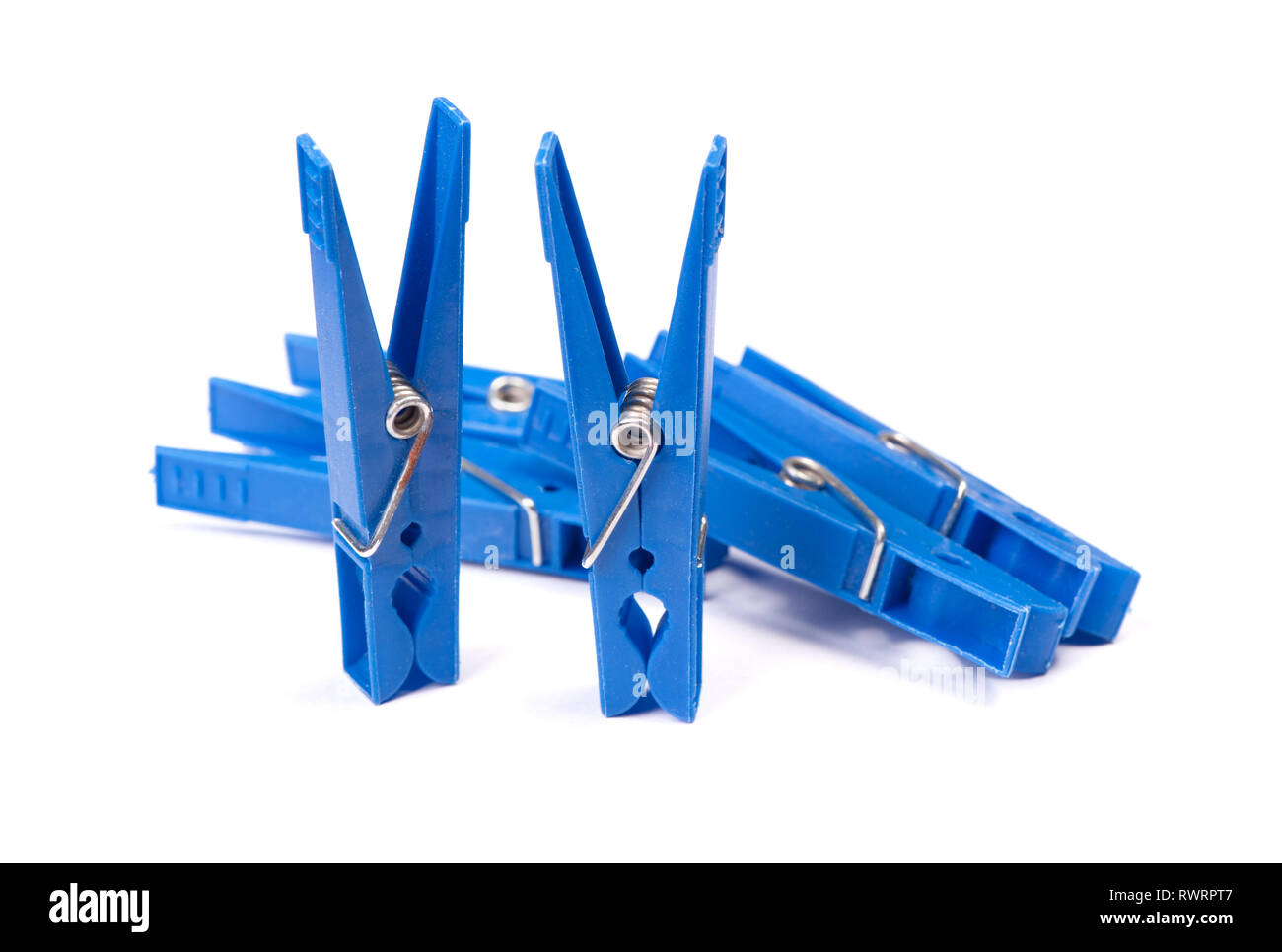 Blue plastic clothespins isolated on white background Stock Photo
