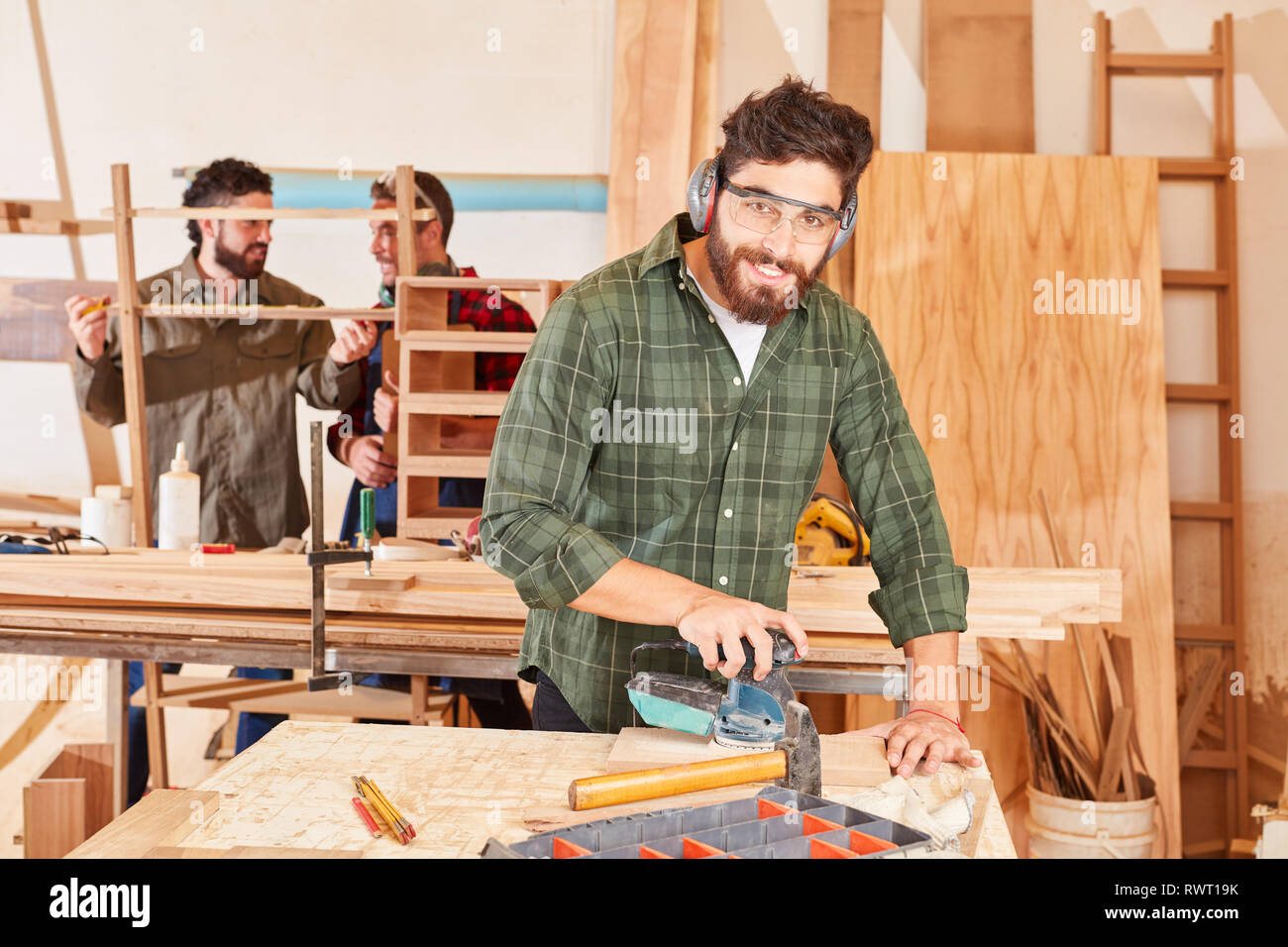 Young Man As A Carpenter Apprentice Works With The Grinder In The Joinery Stock Photo Alamy