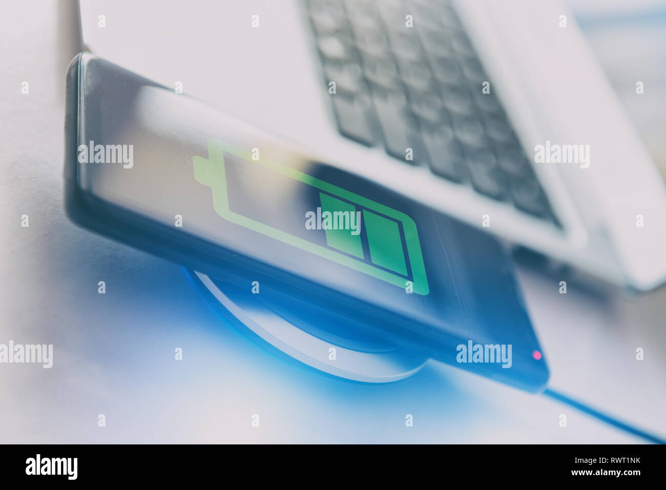 Smartphone on a wireless charging pad, charger. Stock Photo