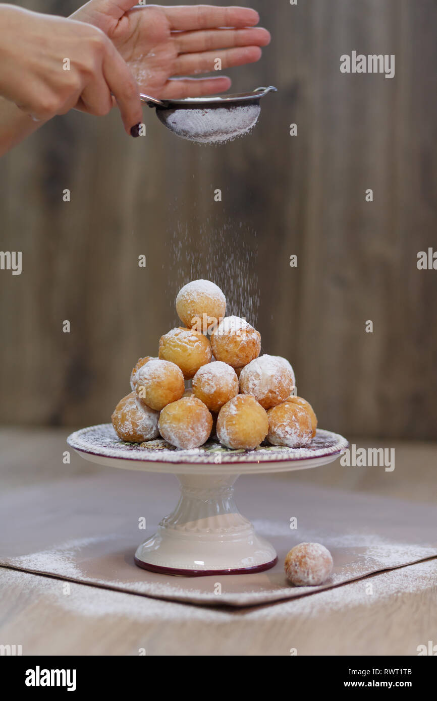 Donuts on a tray sprinkled with powdered sugar. Stock Photo