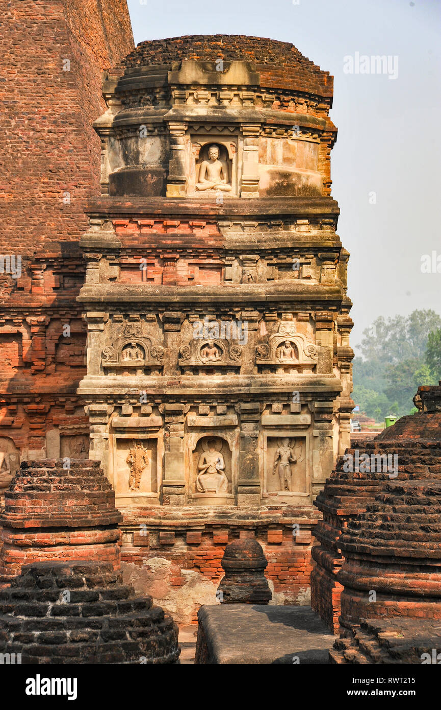 INDIA, NALANDA,  Ruins of the ancient Buddhist monastery Mahavihara with stucco figures of Buddha Stock Photo