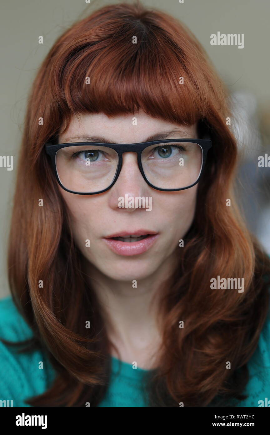 red haired woman with eye glasses  and a preaty face Stock Photo