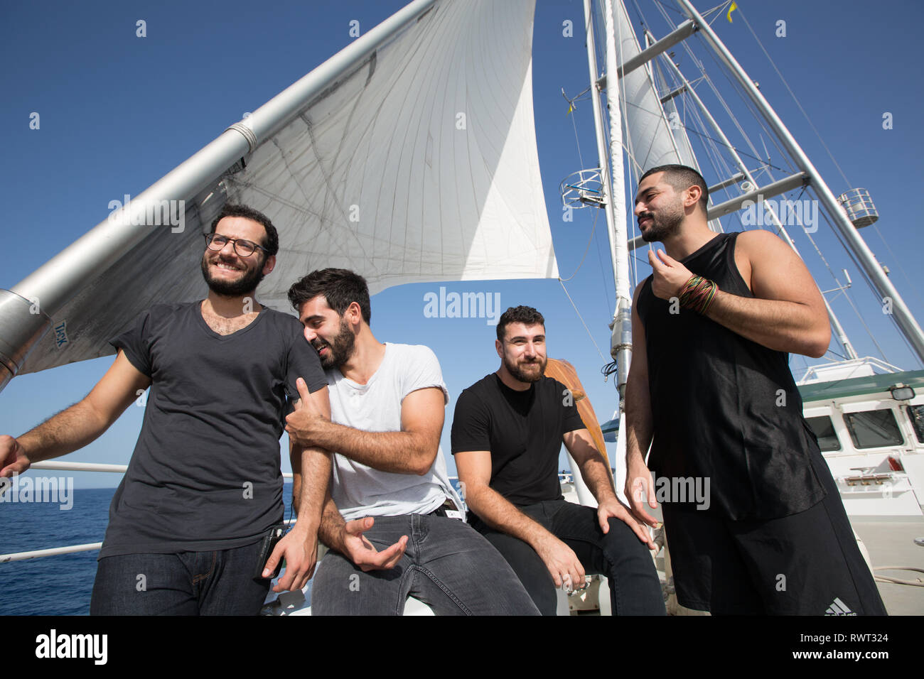 Lebanese band Mashrou' Leila set up and prepare to record a song aboard Greenpeace's Rainbow Warrior ship on The Sun Unites Us tour, Mediterranean Sea, on 23 October 2016.   N37°57.583' E9°08.559' Stock Photo