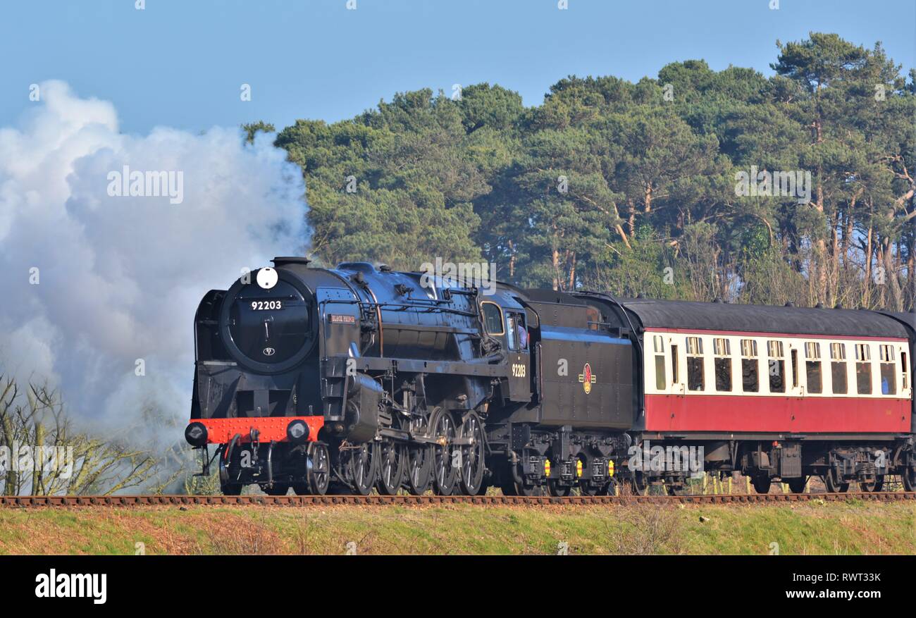 Black Prince, large black steam engine steaming through the countryside on a bright sunny day Stock Photo