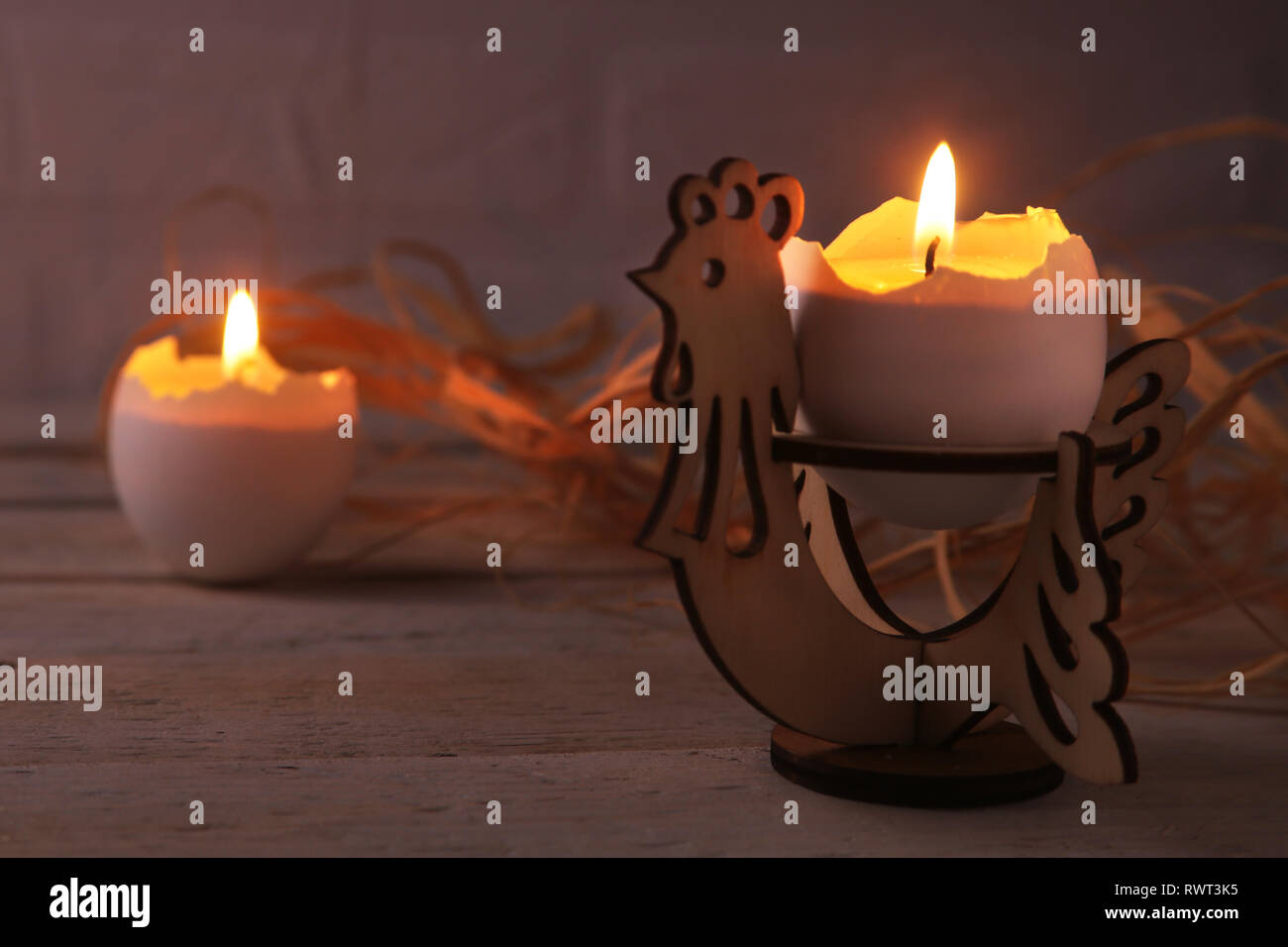 Happy easter composition with eggs and candles on Rustic background. Selective focus. Stock Photo