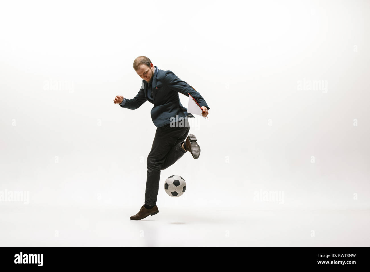 Businessman with football ball in office. Soccer freestyle. Concept of  balance and agility in business. Manager perfoming tricks isolated on white  studio background Stock Photo - Alamy