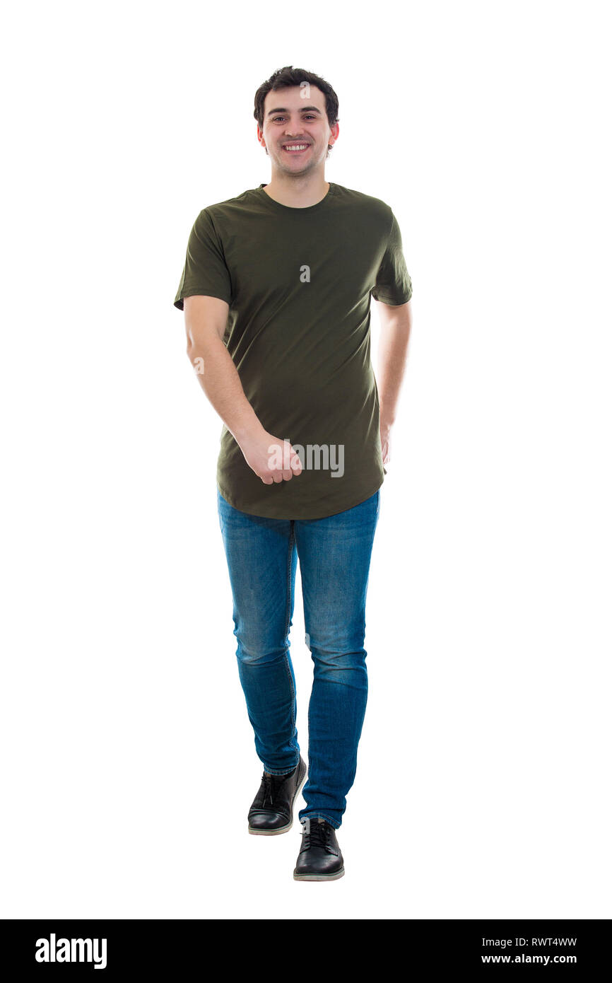 Full length portrait of casual young man confident walking towards camera isolated over white background. Motion shot, happy facial expression. Stock Photo