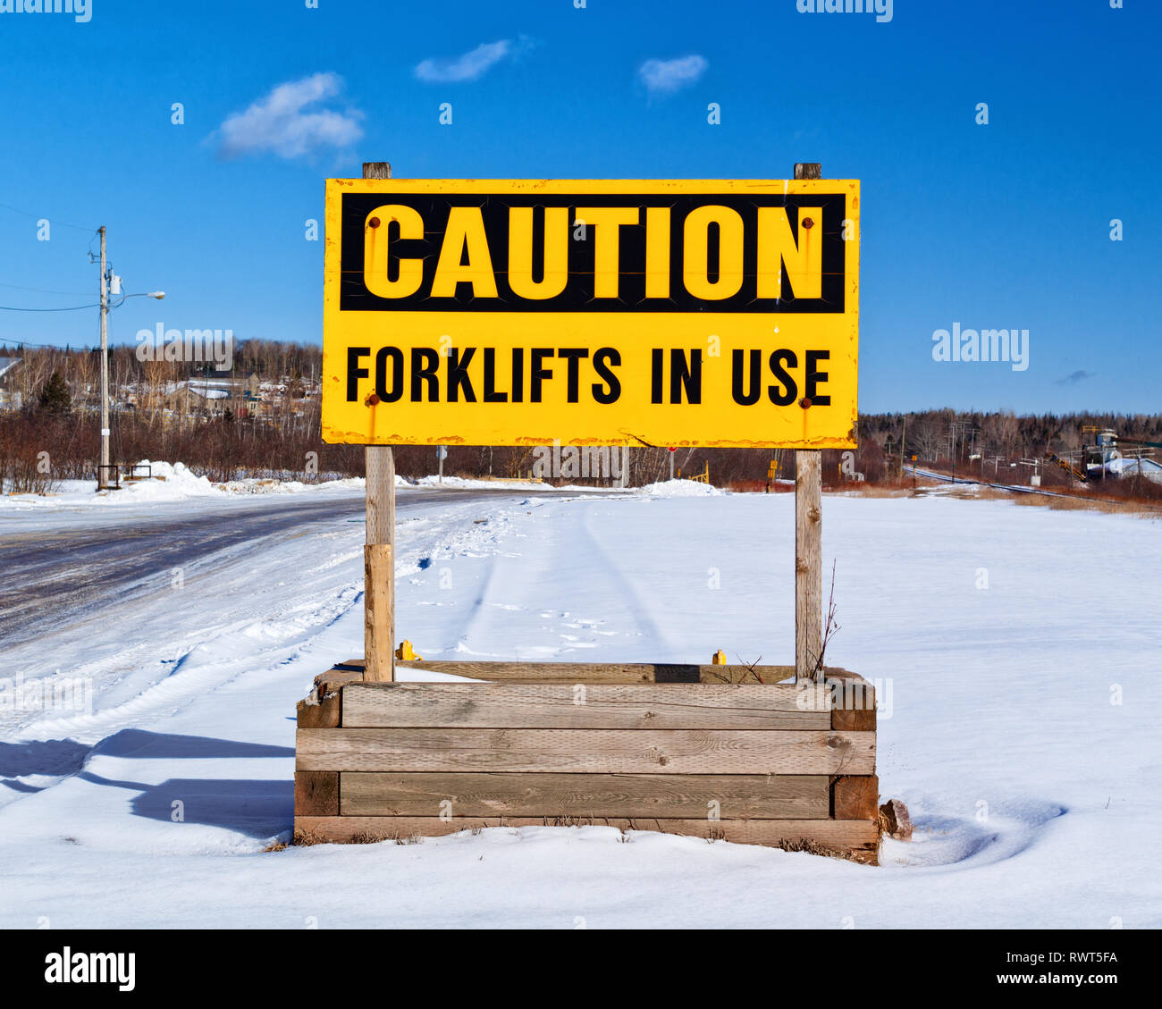 Caution, forklifts in use sign during winter. Stock Photo