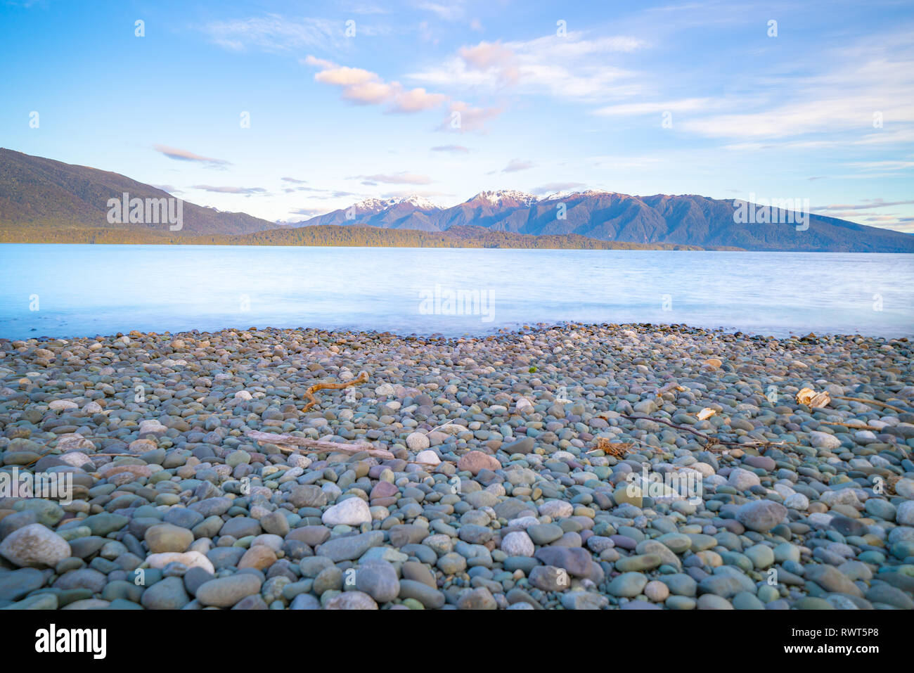 Lake Te Anau looking along the length to Murchison Mountain Range from shore across turquoise blue water. Stock Photo