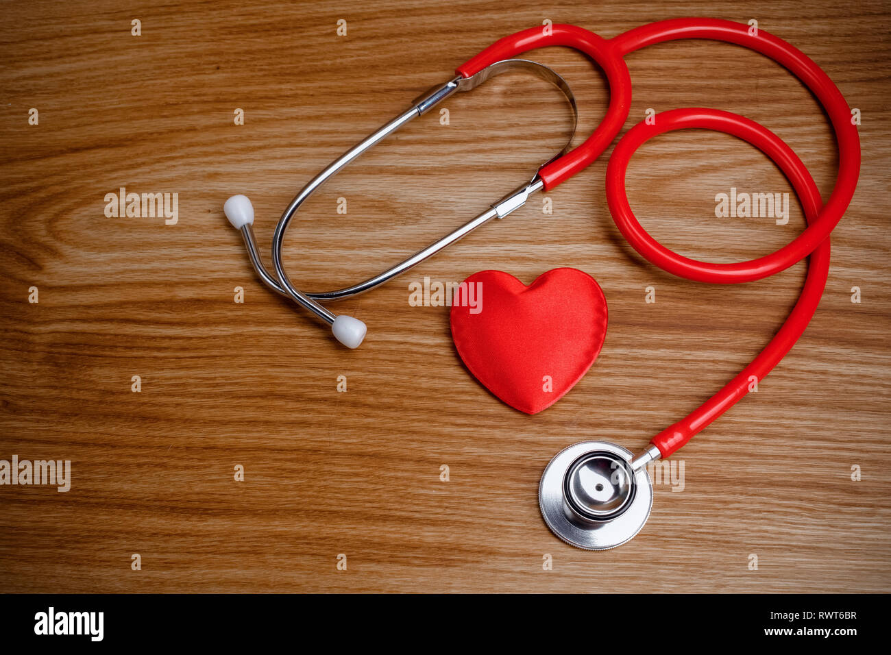 Stethoscope with red heart on a wood background Stock Photo - Alamy