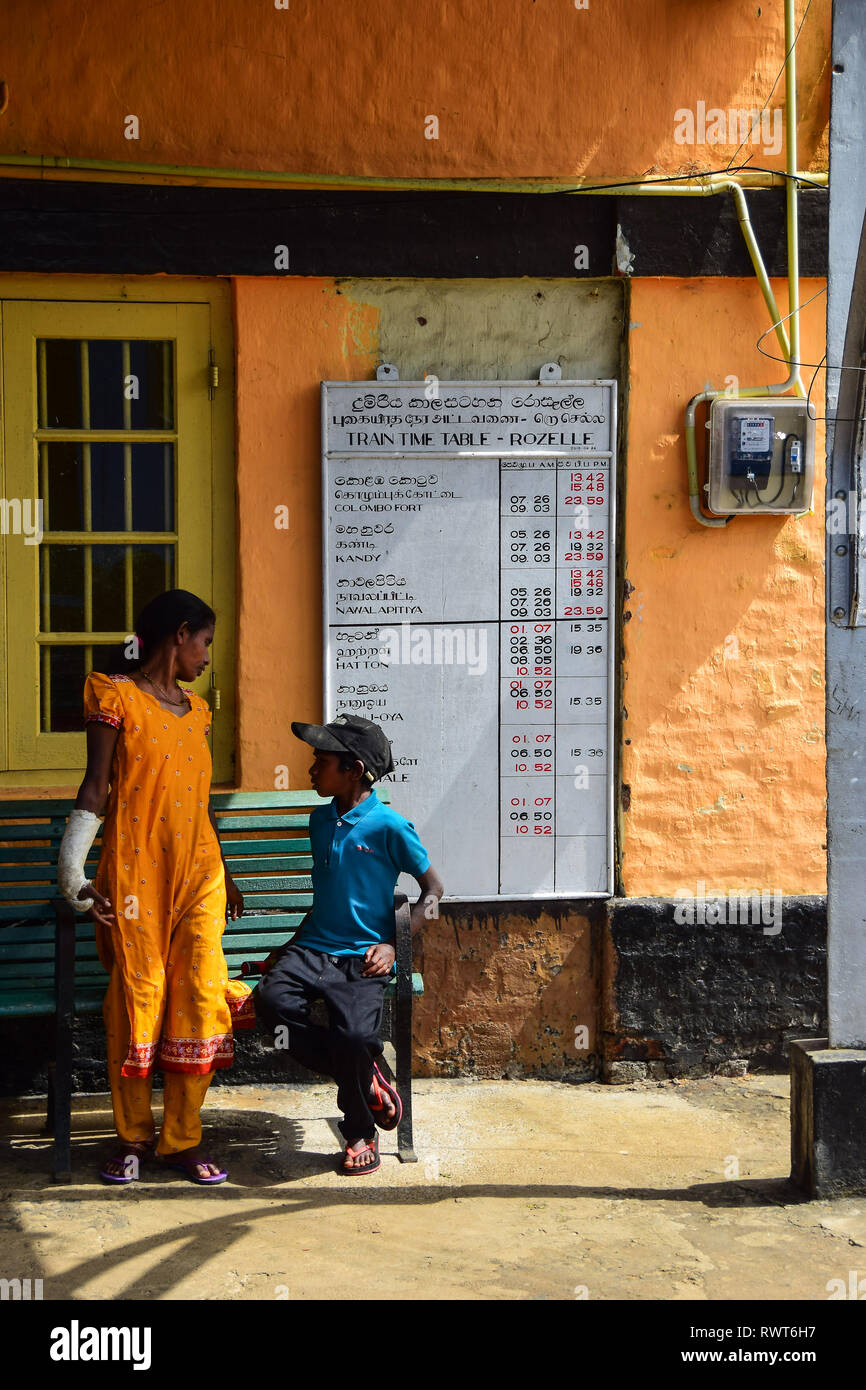 Sri Lankan Mother & Son, Train Platform, Train Timetable, Rozelle, Sri Lanka Stock Photo