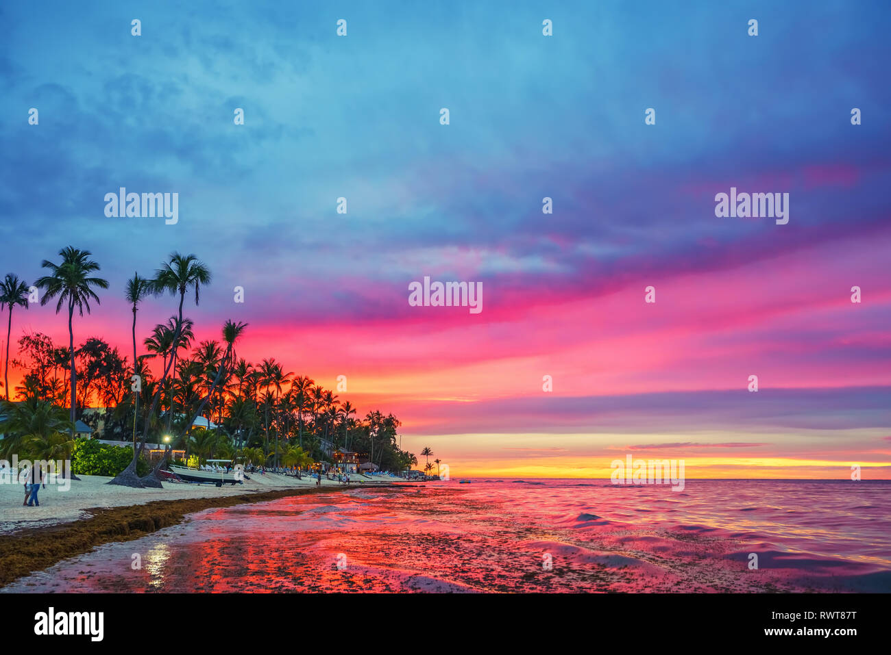Sunset over tropical beach Stock Photo - Alamy