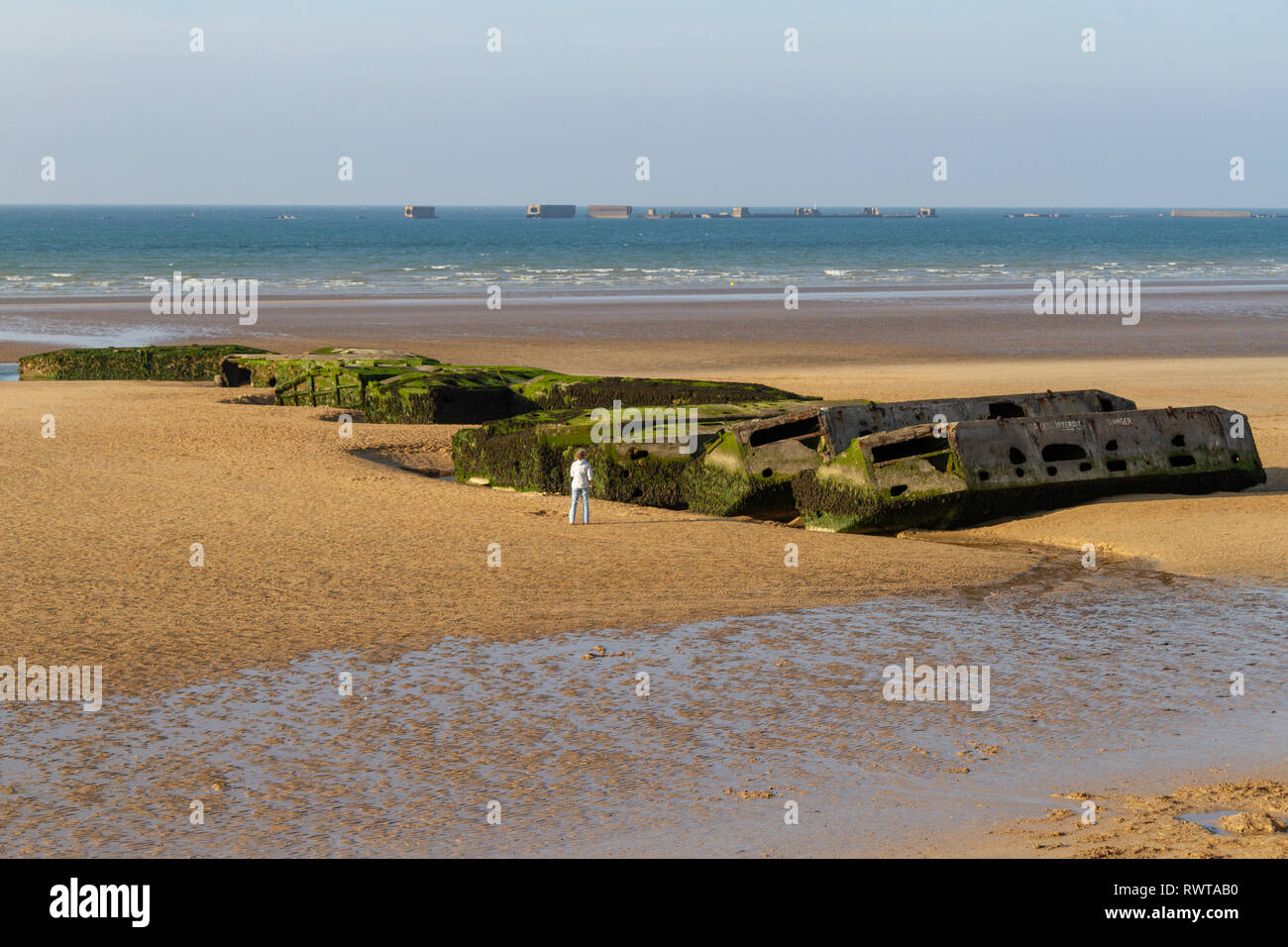 'Beetle' pontoons, part of the Mulberry Harbour, stranded on the beach at Arromanchess (Arromanches-les-Bains), Normandy, France. Stock Photo