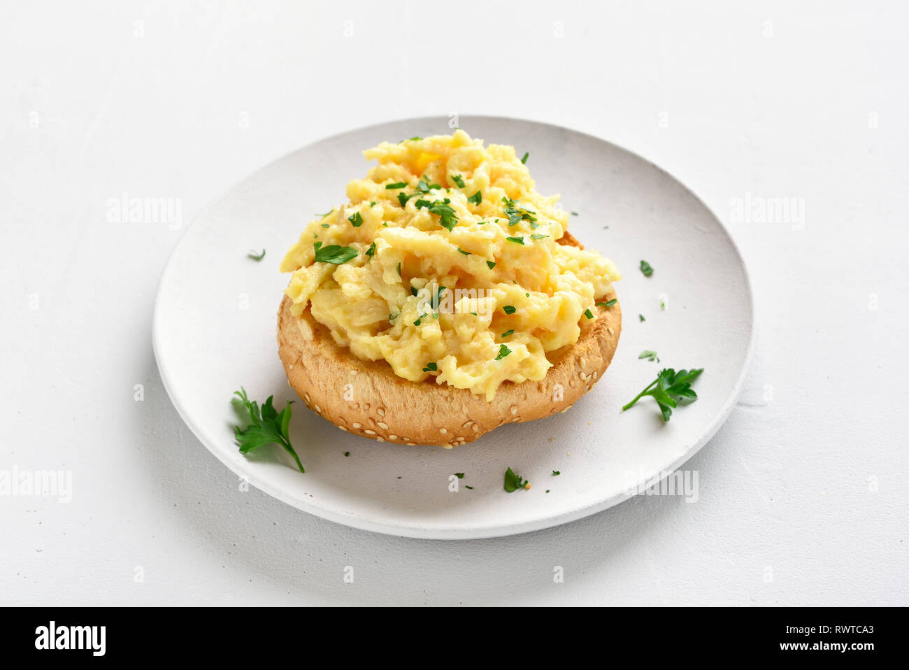 Scrambled eggs, omelette on bun. Healthy snack for breakfast Stock