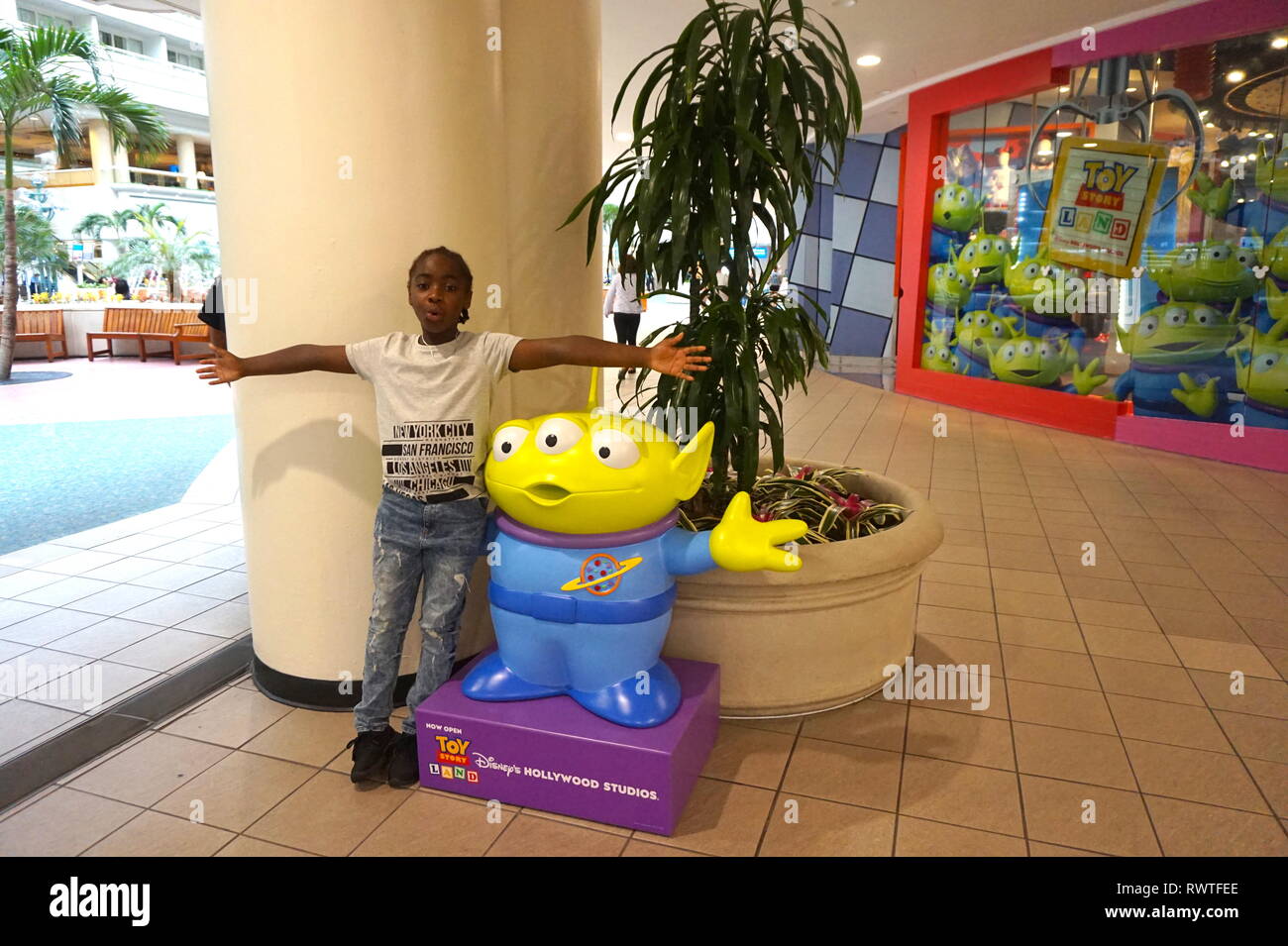 Young boy posing next to statue at Orlando International Airport, USA Stock Photo Alamy