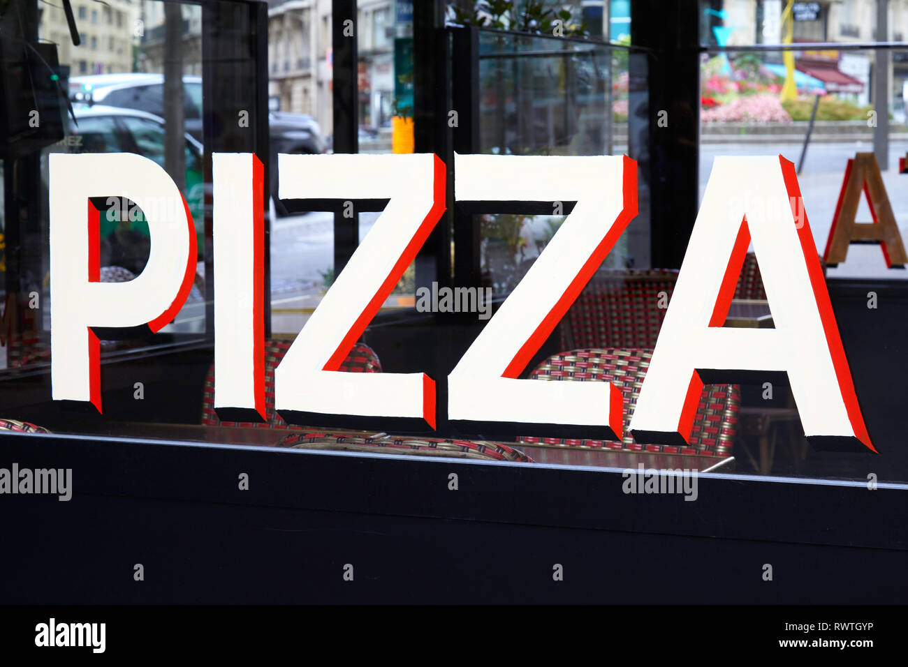 Pizza sign in white, black and red letters on restaurant glass in Italy Stock Photo