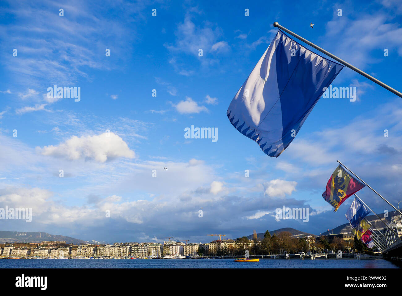 Flags of Swiss cantons fly in the wind, Mont-Blanc Bridge, Geneva, Swiss Stock Photo