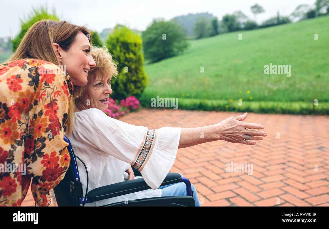 Senior woman in a wheelchair with her daughter Stock Photo