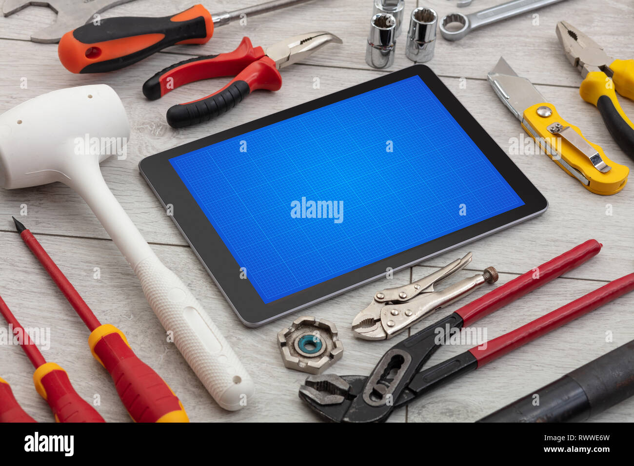 Household tools and tablet with grid screen concept Stock Photo