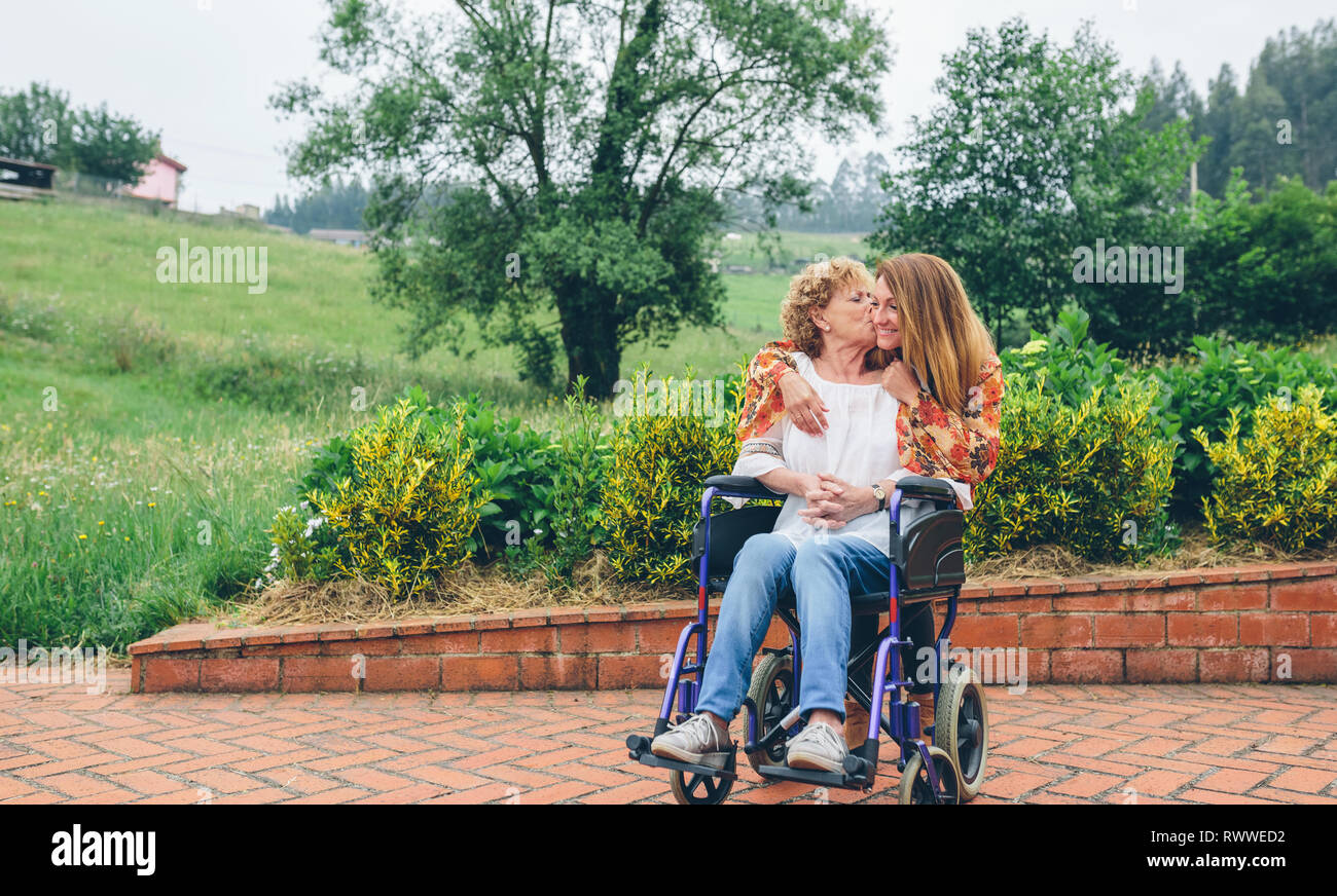 Mother daughter embracing girl kissing hi-res stock photography and