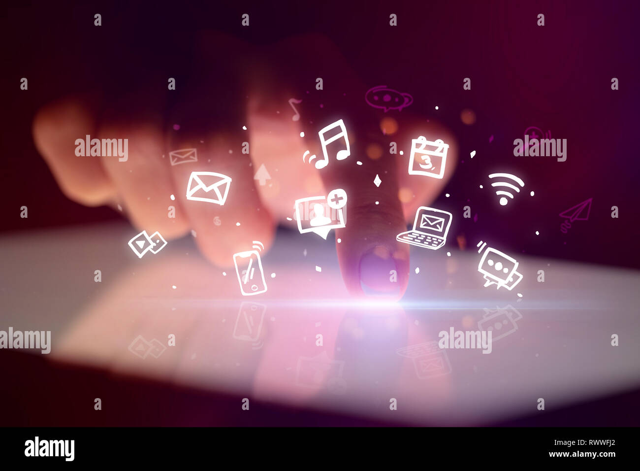 Finger touching tablet with hologram application icons and dark background  Stock Photo