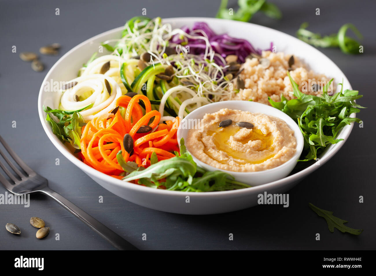 veggie couscous lunch bowl with spiralazed carrots and zucchini, hummus