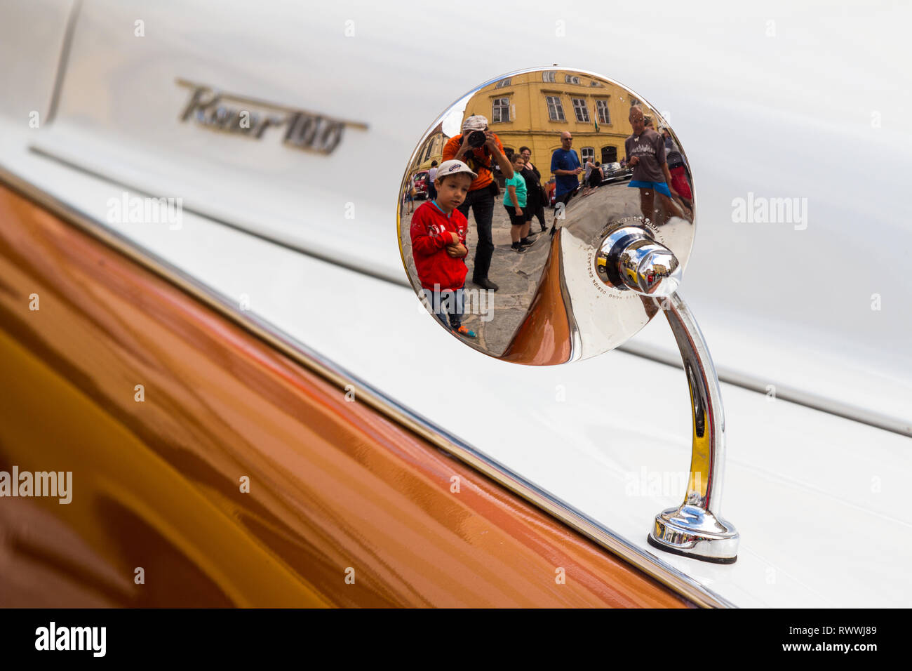 Detail of vintage Rover 100 at car show in Sopron, Hungary. People refleced in the rear side of rearview mirror. Stock Photo