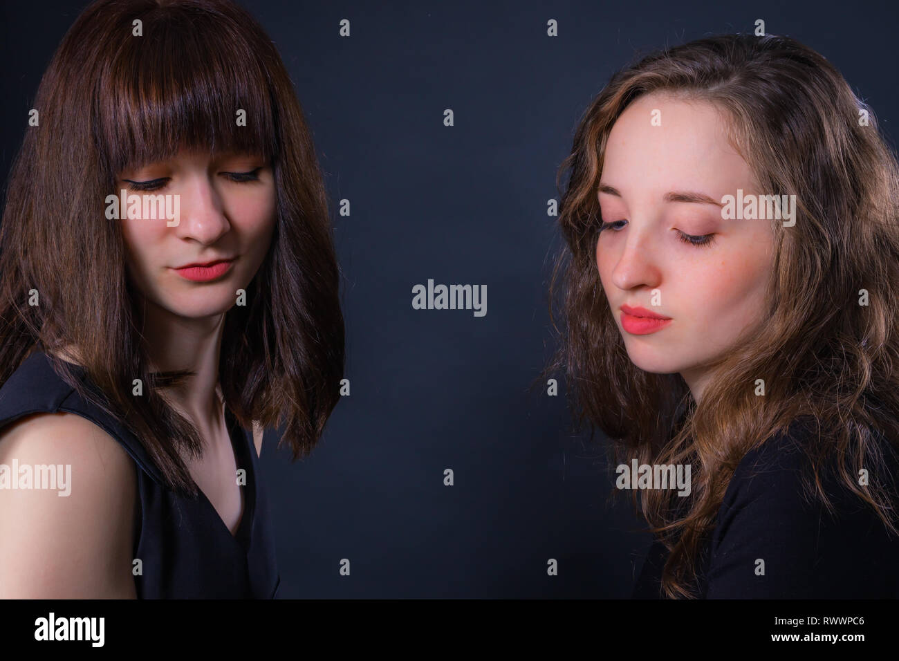 Group portrait of two girls on a dark background Stock Photo