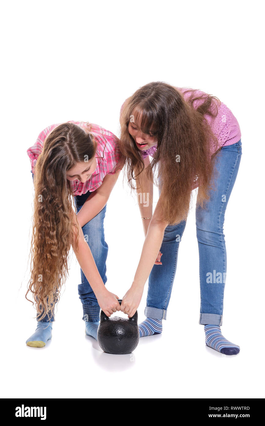 Funny concept, Sisters amicably lifting a weight. Isolation on a white background Stock Photo