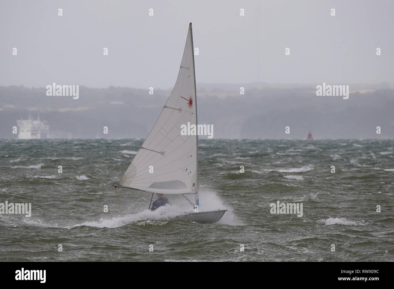 Exhilarating dingy racing in a storm. Monochrome drama battling the sea. Stock Photo
