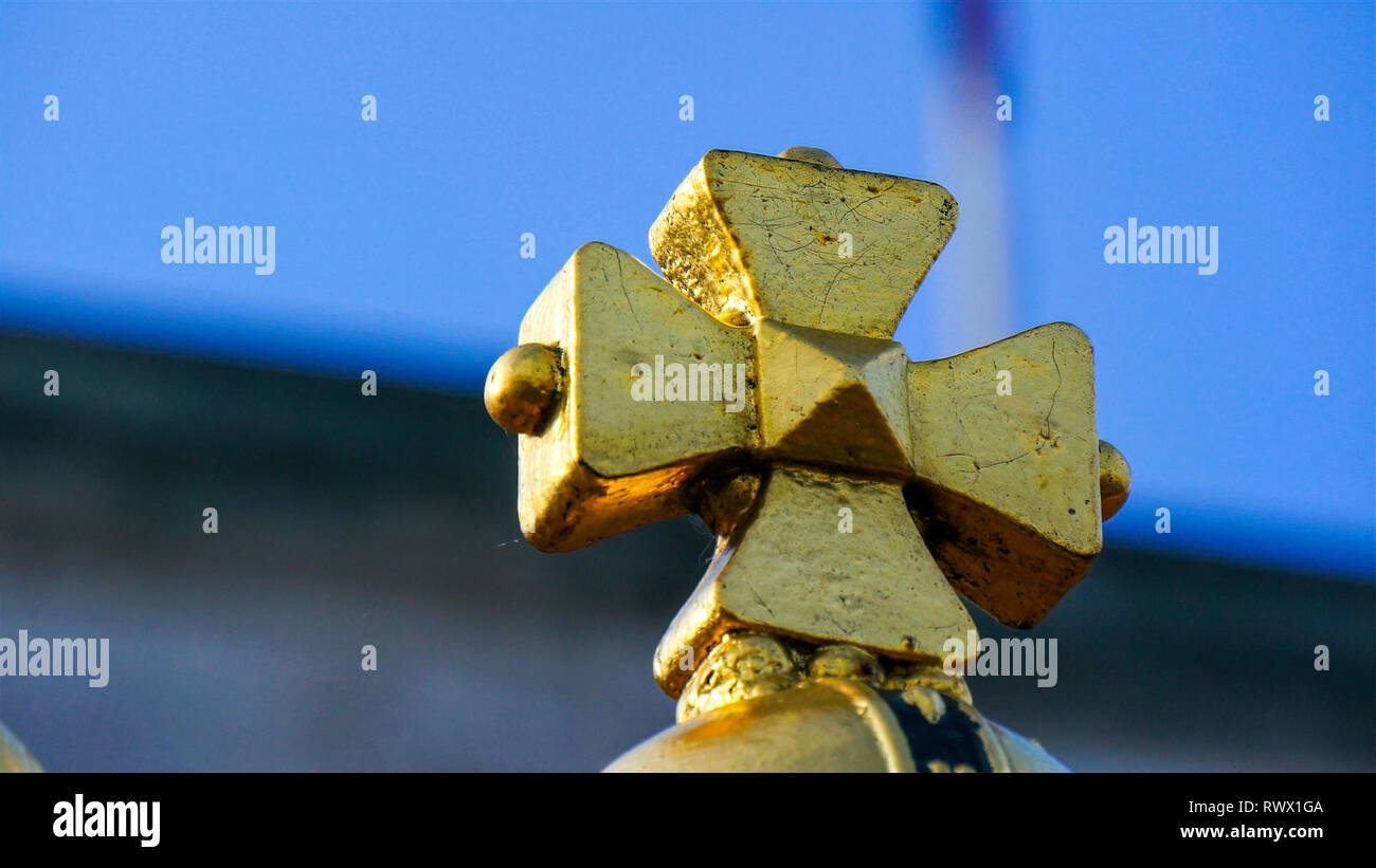 The flag and the golden cross in Buckingham Palace. Buckingham Palace is the London residence and principal workplace of the monarchy of the United Ki Stock Photo