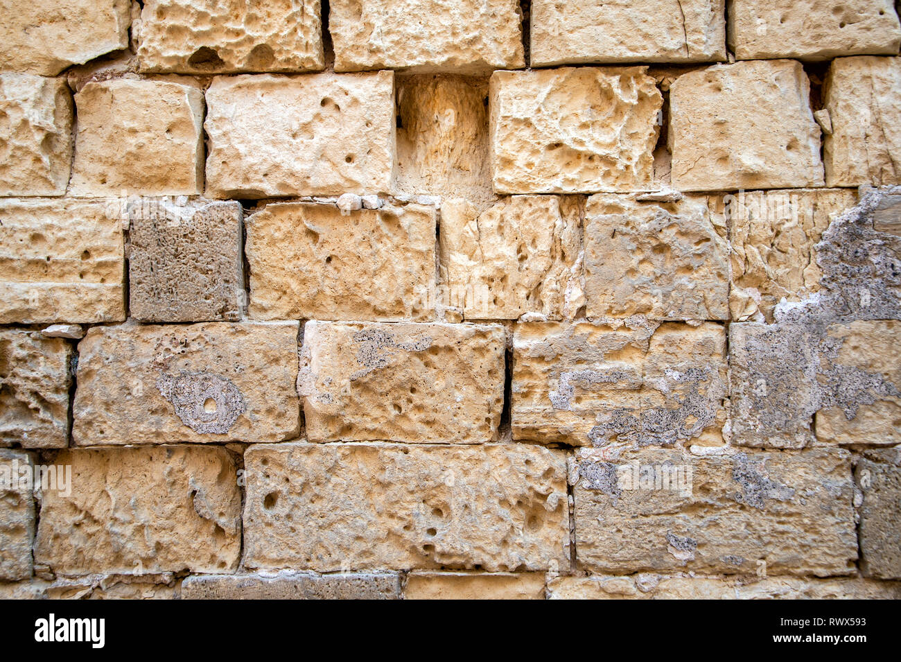 wall of old limestone blocks, exterior. Stock Photo