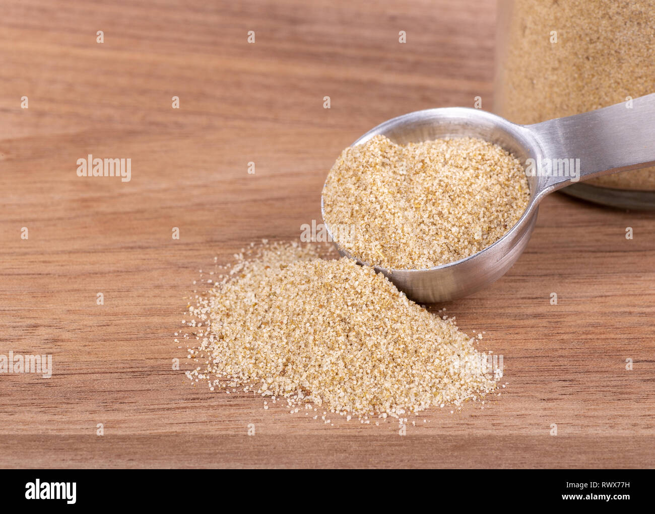 Closeup of celery salt seasoning and a measuring spoon on a wooden table with copy space Stock Photo