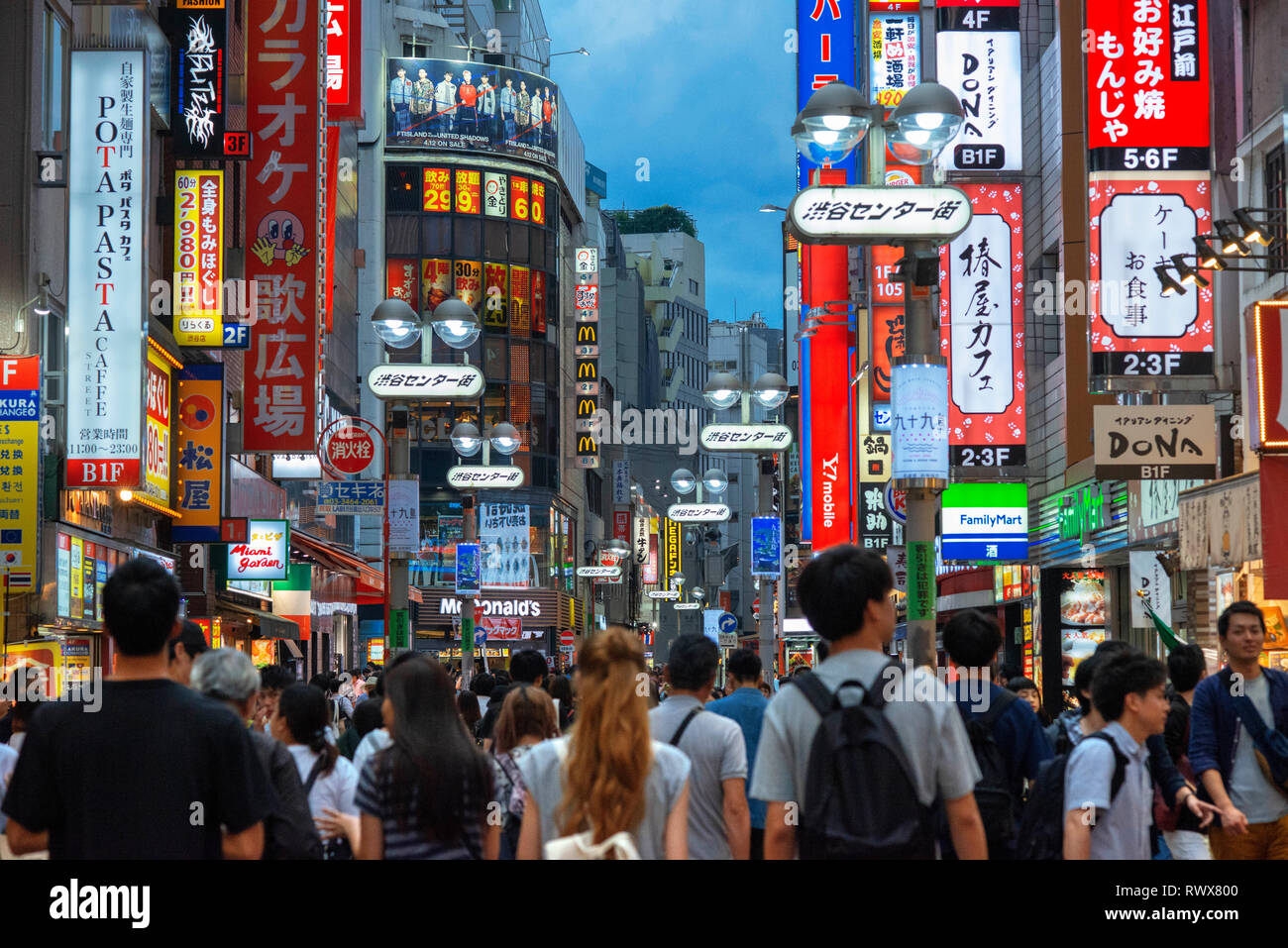 Advertising signs overhanging the streets in the Shibuya shopping district of Tokyo, Japan, Asia Stock Photo