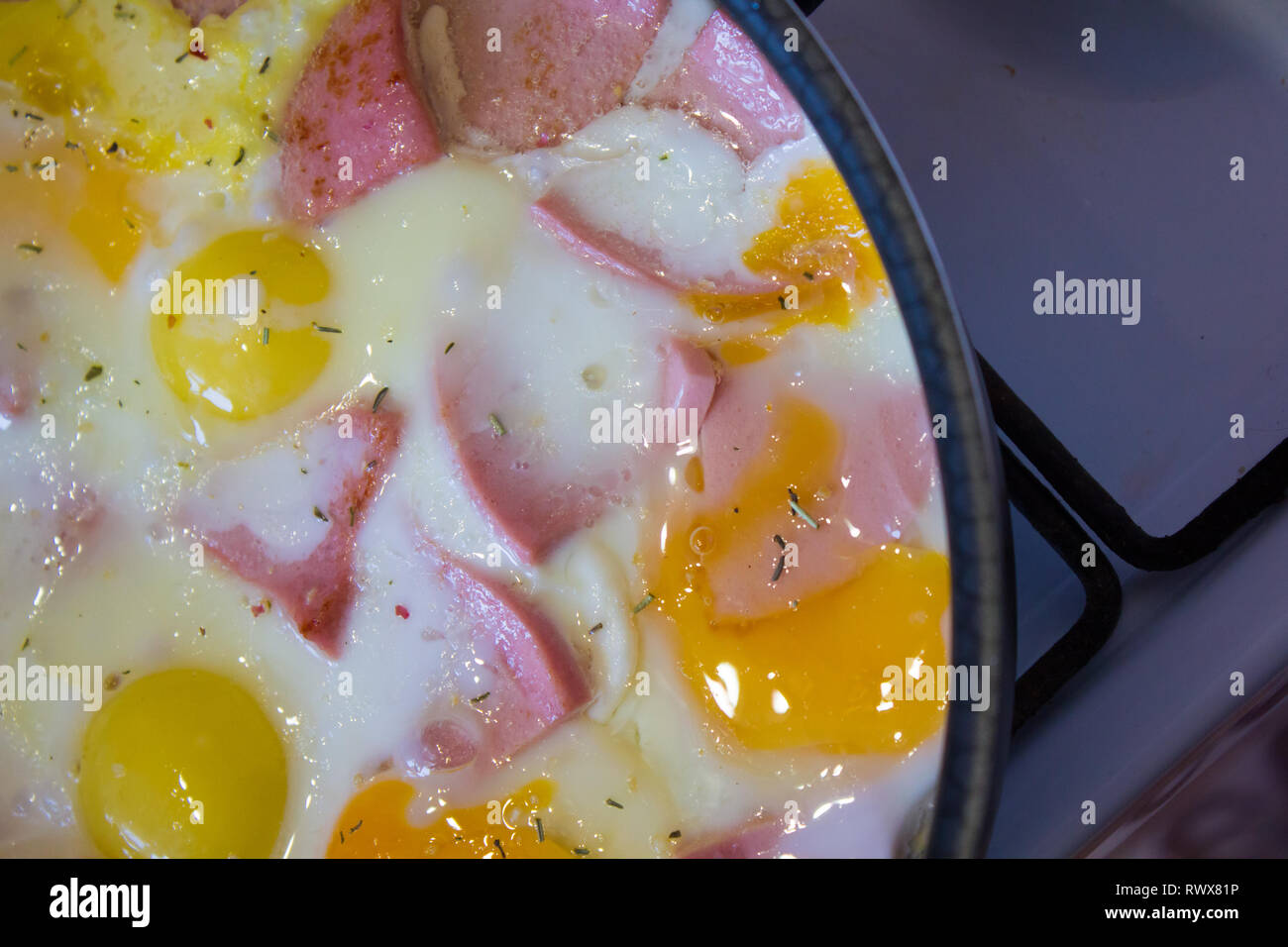 fried eggs in a pan with sausage. Cook at home. fried food. unhealthy