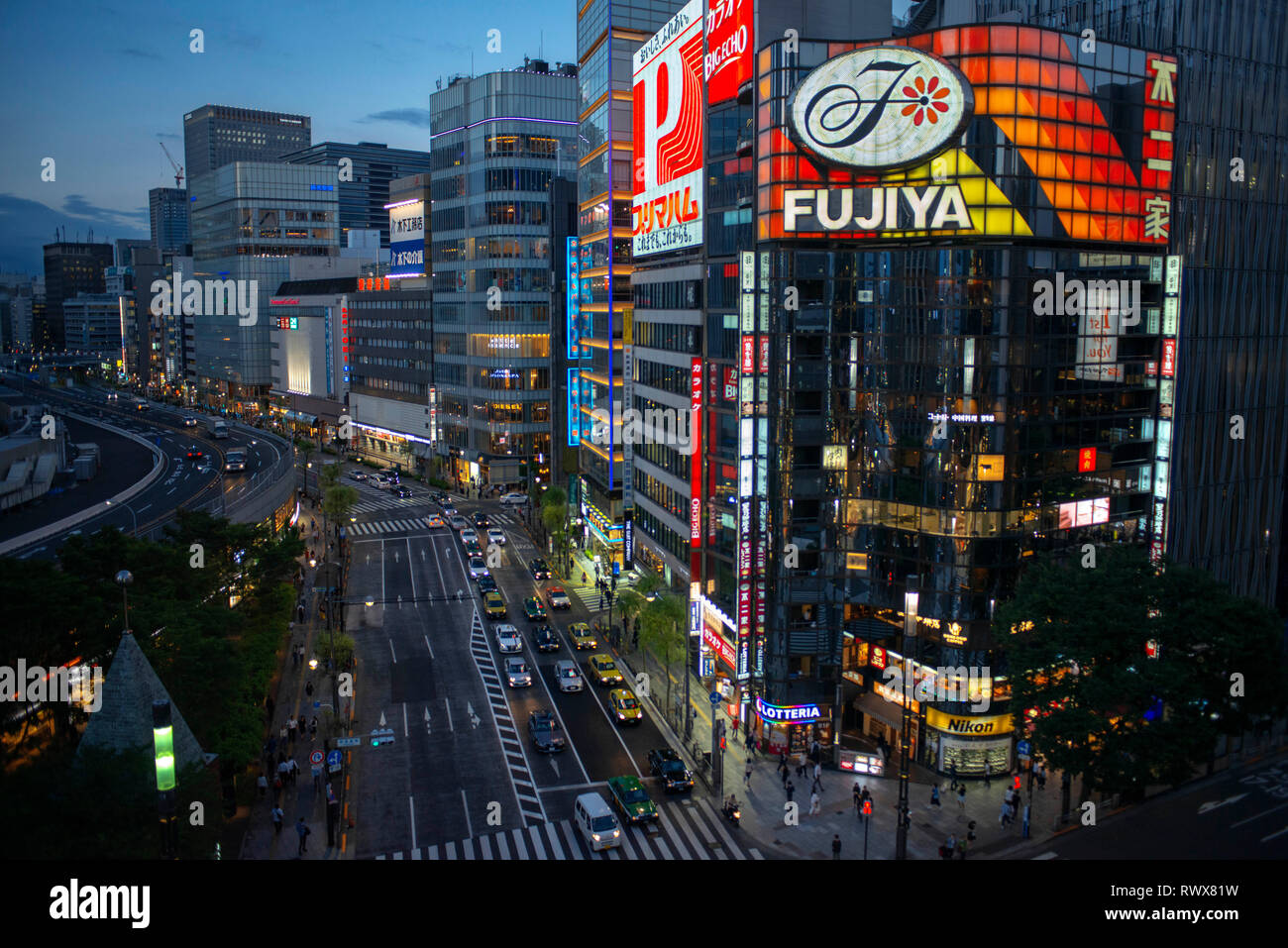 The Ginza district at night. Ginza is a popular upscale shopping area of Tokyo Stock Photo