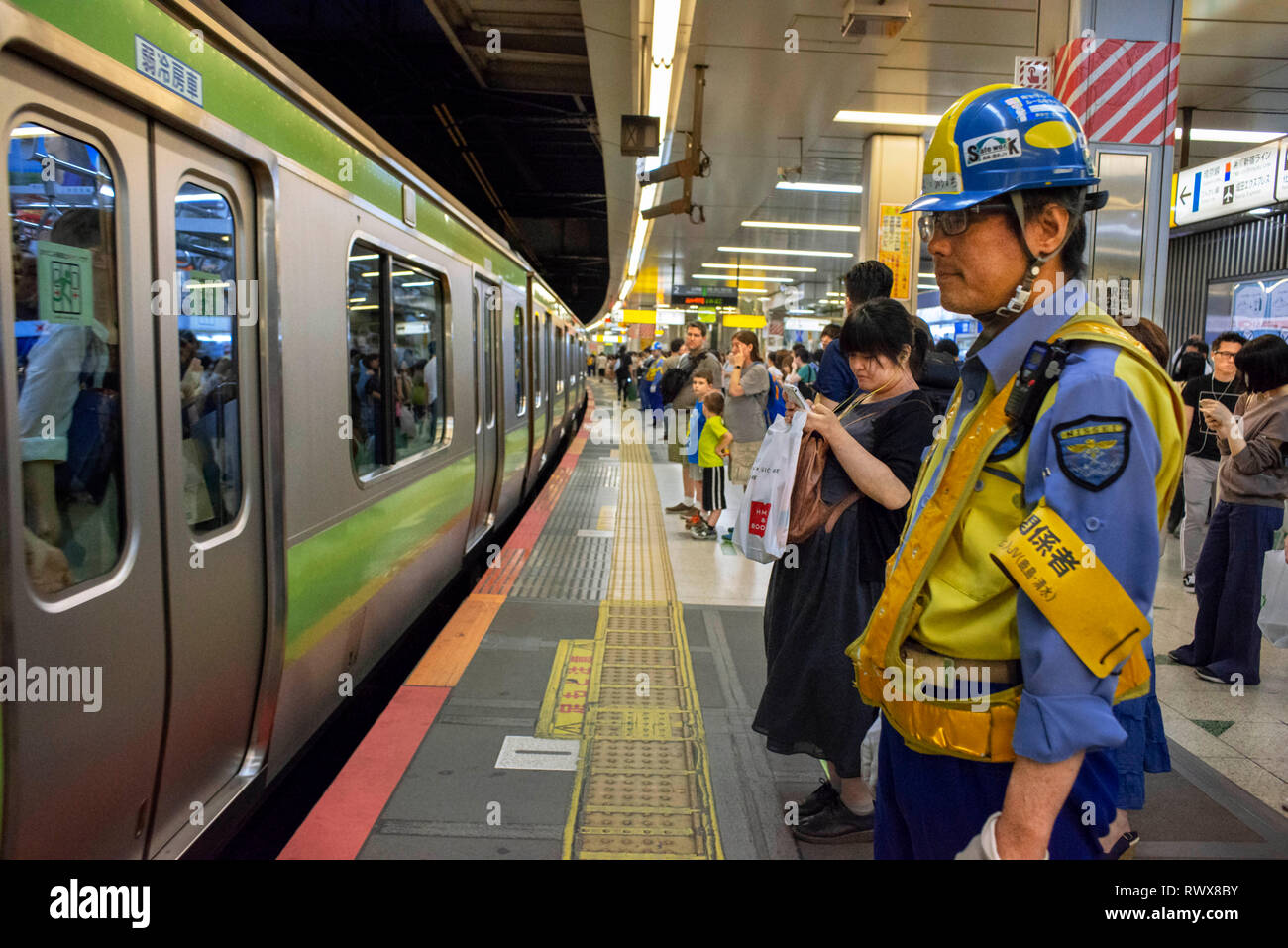 Japanese people in underground station, Asian commuters traveling during rush hour, tourists on subway train. Tokyo, Japan, Asia Stock Photo