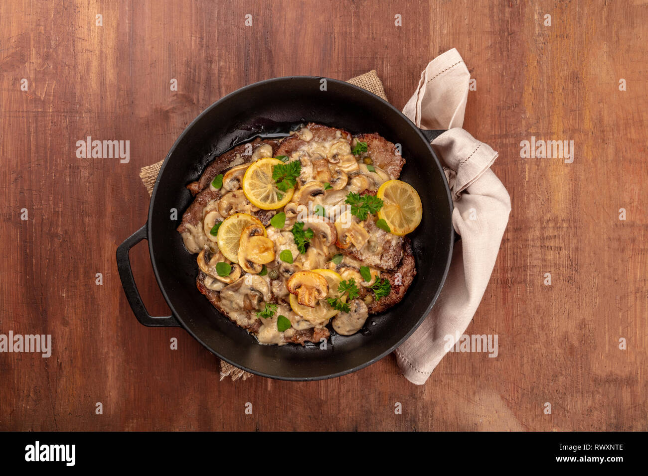 Scallopine di vitello, veal scallopini, a traditional Italian dish with mushrooms, lemons, and