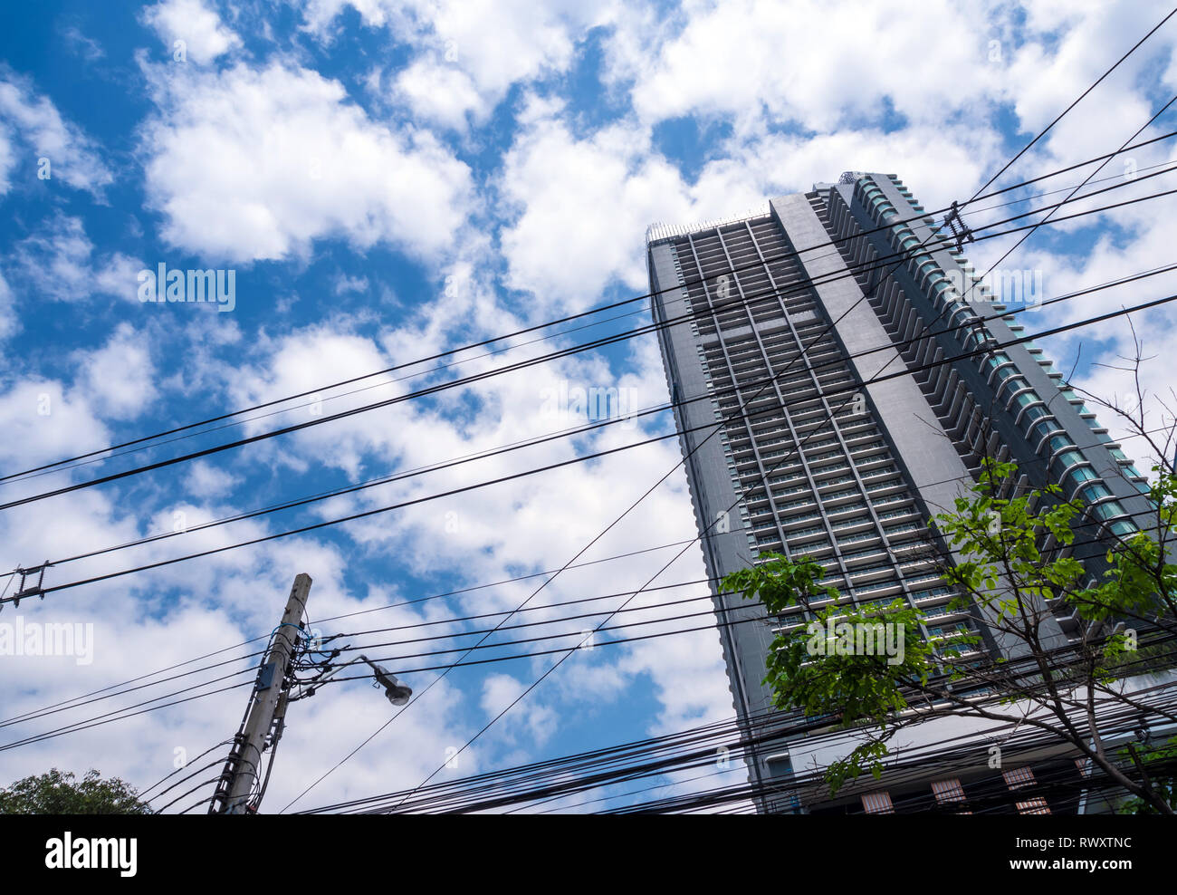 High Rise Building Power High-rise building and the intricate across power line Stock Photo - Alamy