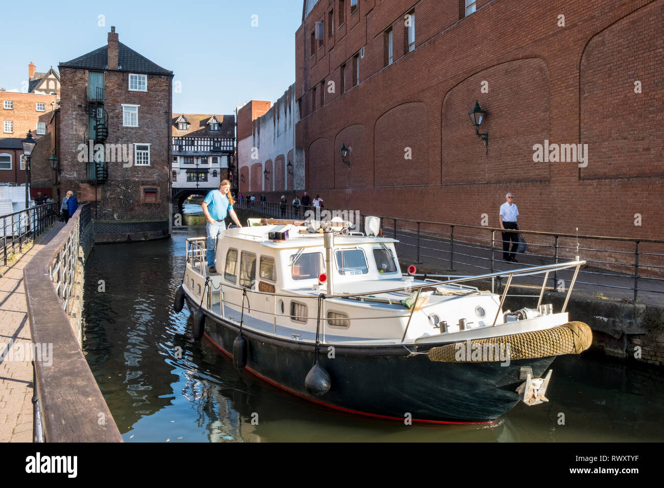 A boat sailing on the River Witham with the Glory Hole and High Bridge in the distance, Lincoln, England, UK Stock Photo