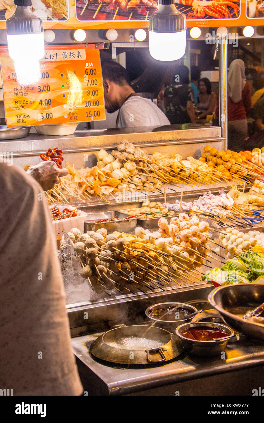 fried and BBQ meat skewers stall at Jalan Alor food street and night market in Kuala Lumpur Malaysia Stock Photo