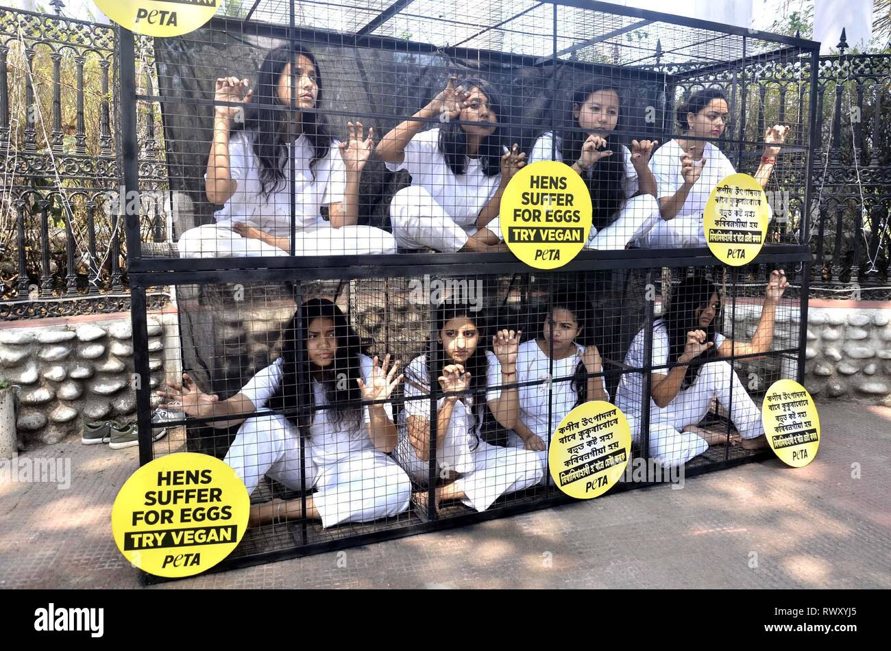 Guwahati, Assam, India. 07th Mar, 2019. Activists of PETA demonstrating by caging themselves in solidarity with hens in Guwahati ahead of the International Women Day on Thursday, 07 March 2019. During the International Women Day on March 8, Women in Guwahati will embrace this year's theme “Balance For Better” and cram themselves into Cage. Credit: Hafiz Ahmed/Alamy Live News Stock Photo