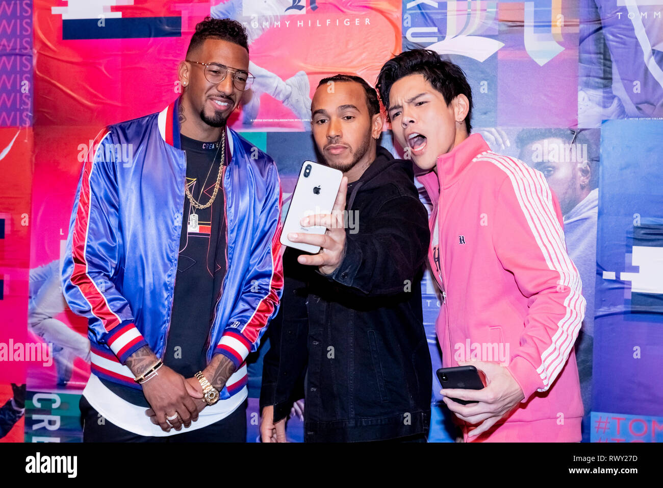 Berlin, Germany. 07th Mar, 2019. Jerome Boateng (l-r), soccer player, Lewis  Hamilton, racing driver, and Jacky Heung, actor, stand in front of a photo  wall at the Tommy Hilfiger CREATExUNITY event and