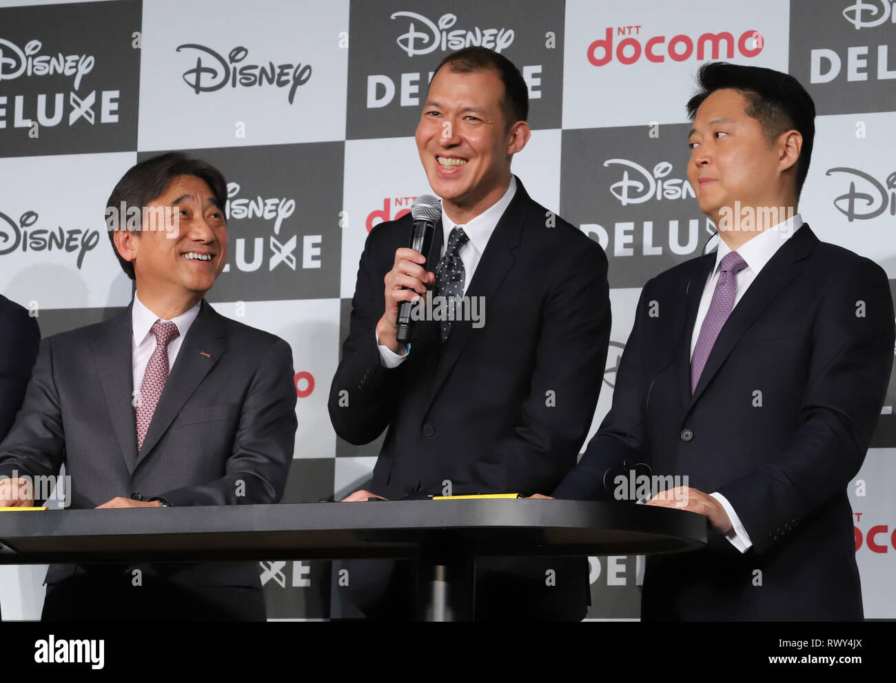 Tokyo, Japan. 7th Mar, 2019. Japan's mobile communication giant NTT Docomo  president Kazuhiro Yoshizawa (L), Walt Disney executive vice president and  managing director of North Asia Luke Kang (R) and Walt Disney